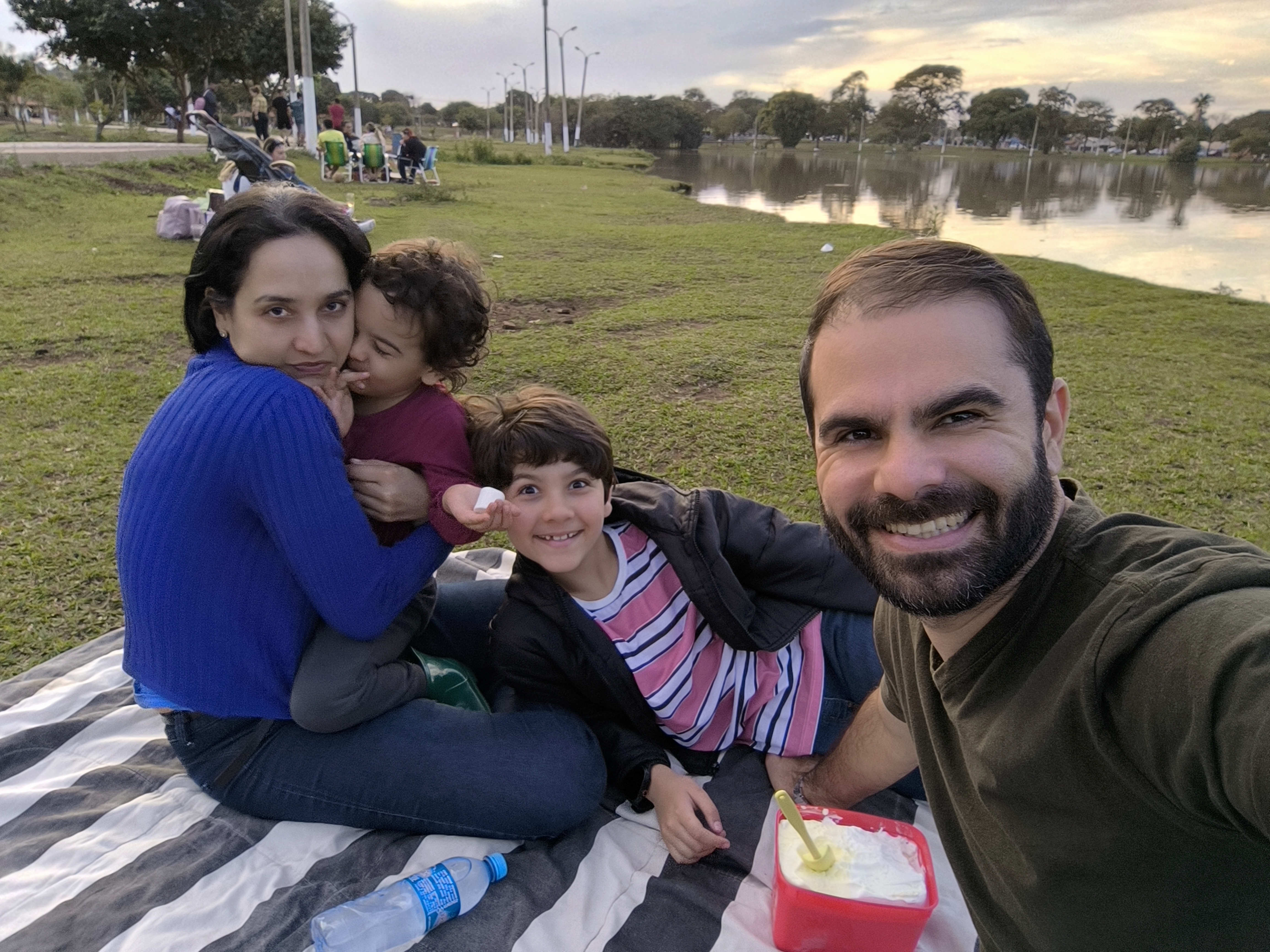 Família em piquenique à beira do lago